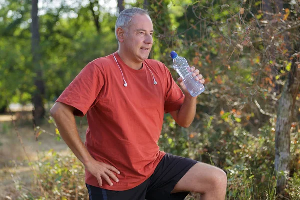 Man Runner Running Forest Drinking Water — Stock Photo, Image