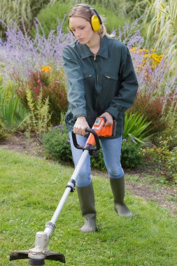 a woman trims the lawn clipart