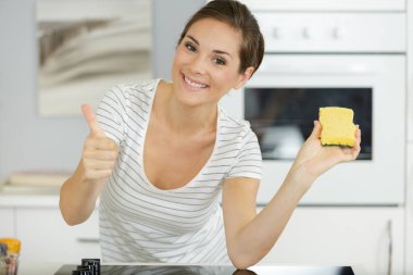 close-up the young happy woman cleaning at home clipart