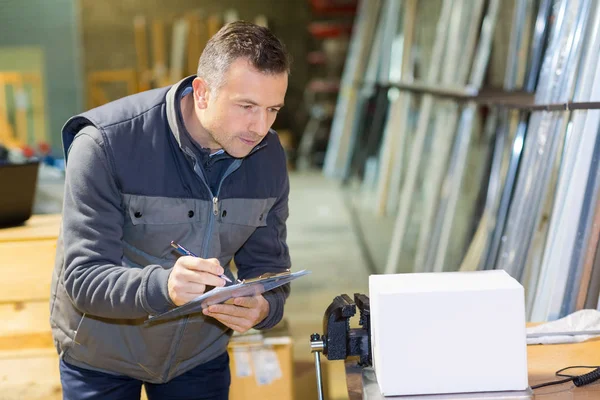 Male Worker Inspecting Blank Box Workshop Bench — Stock Photo, Image