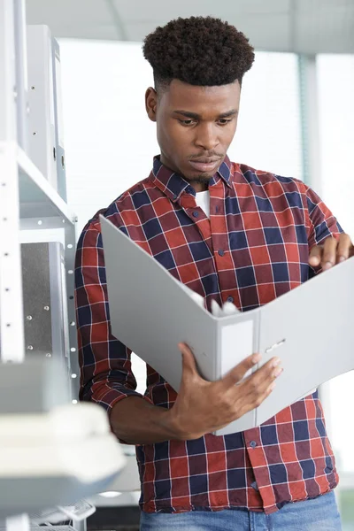 Young Businessman Taking Folder Shelf Workplace — Stock Photo, Image