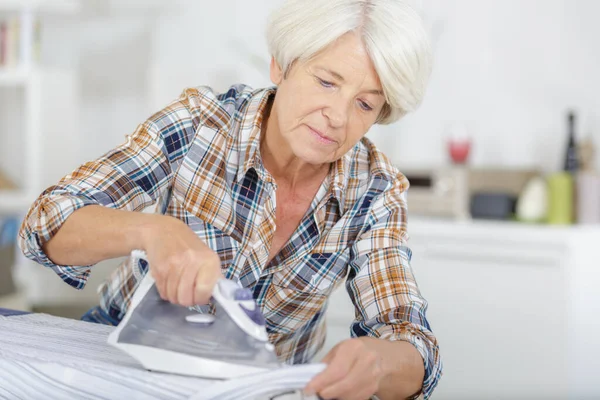 Senior Woman Ironing Clothes — Stock Photo, Image