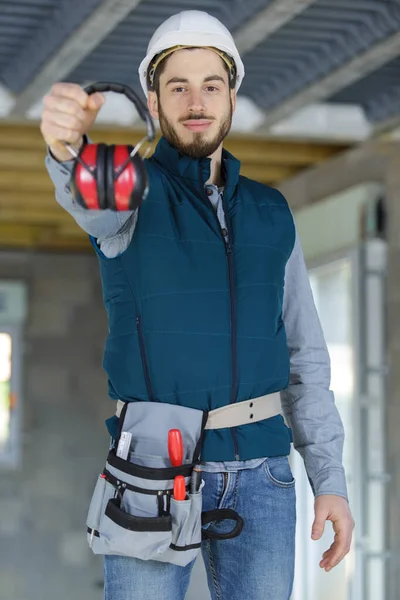 Young Attractive Builder Holding Ear Protection — Stock Photo, Image