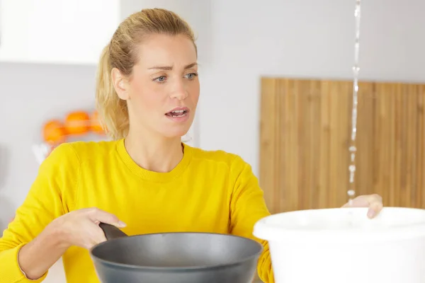 woman with water pipe leak