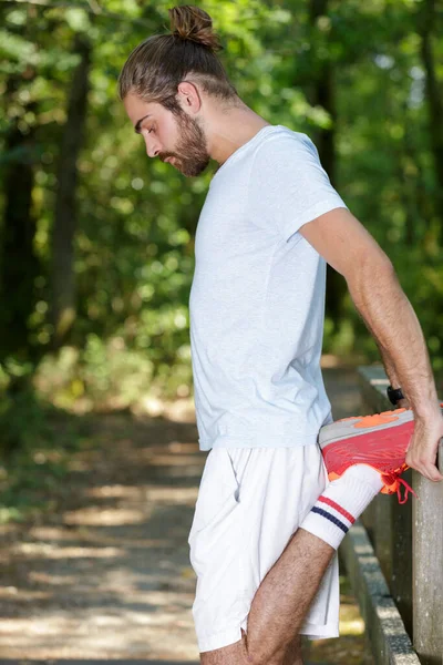 Man Stretching Legs Outdoors — Stock Photo, Image