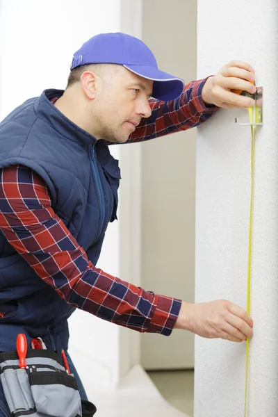 Man Sticking Adhesive Tape Wall — Stock Photo, Image