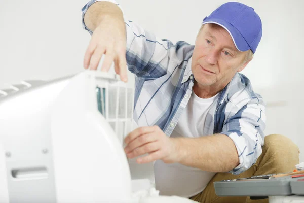 男技术员在室内修理冷气机 — 图库照片