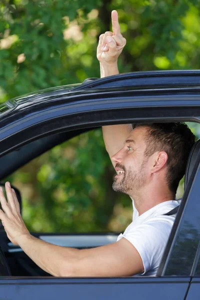 Man Making Offensive Hand Gesture Out Car Window — Stock Photo, Image