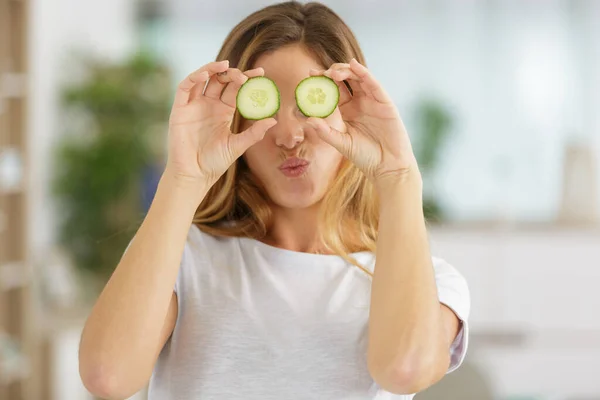 Playful Woman Covering Her Eyes Slices Cucumber — Stock Photo, Image