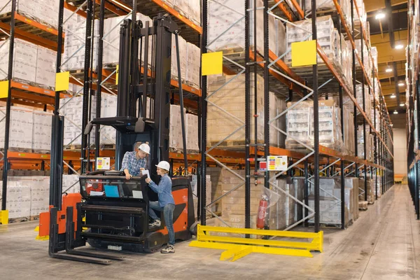 warehouse workers working with forklift loader