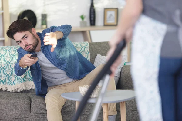 Woman Vacuuming Obstructing Mans Television Remote Control — Stock Photo, Image