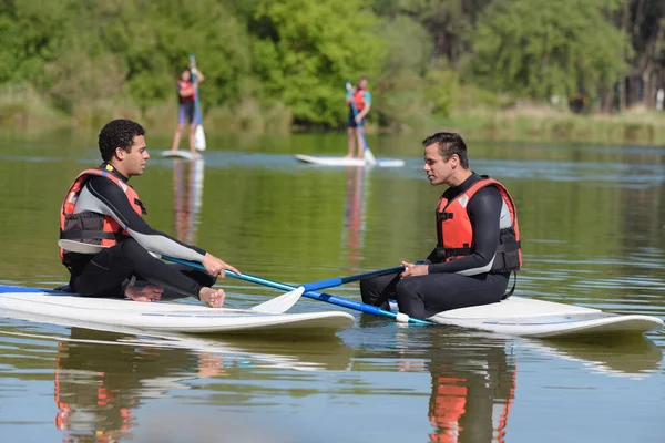 Two Men Wearing Wetsuits Sat Paddle Boards — Stock Photo, Image