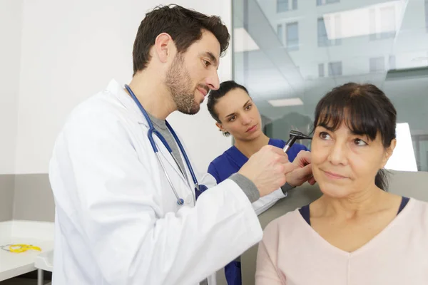 Male Doctor Examining Senior Female Patients Ear Otoscope — Stock Photo, Image