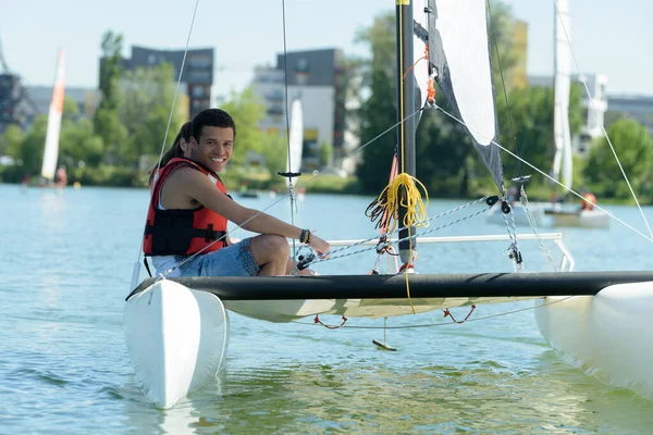 young couple sailing in the lake