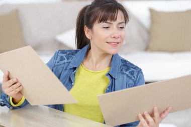 a woman during assembling furniture clipart
