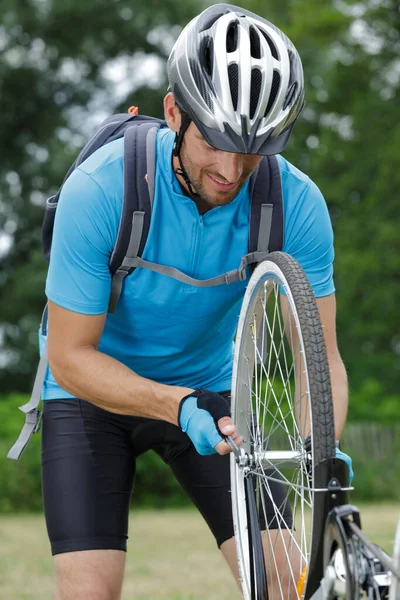 Young Man Cyclist Pumping Wheel Bike — Stock Photo, Image