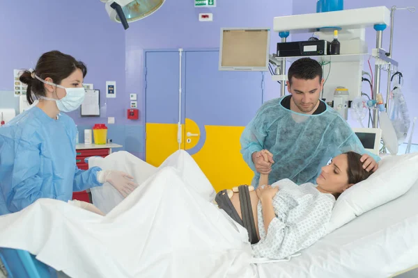 woman giving birth in labor room of hospital