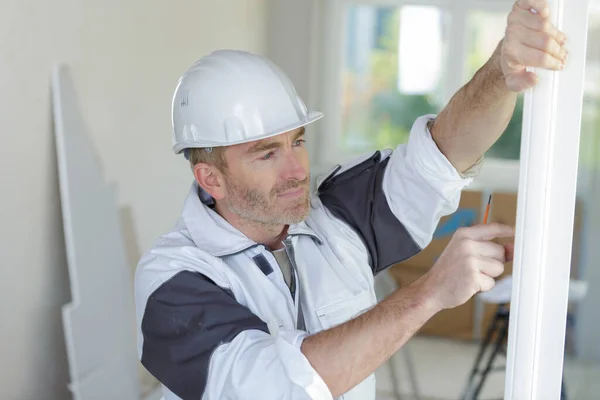 a man is fitting window frame