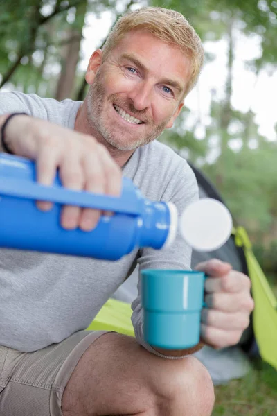Man Pouring Warm Water Plastic Cup — Stock Photo, Image