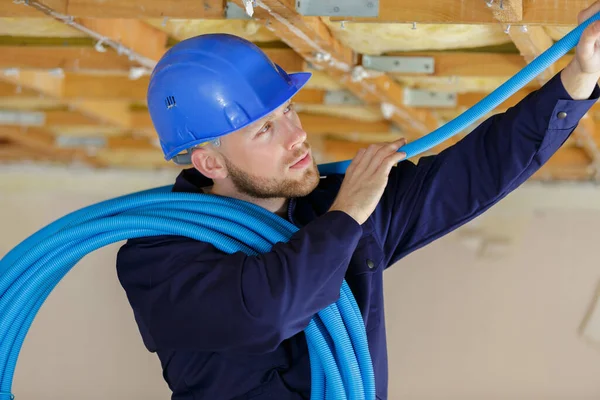 Builder Installing Blue Pvc Pipe — стоковое фото
