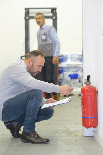 inspecting the fire extinguisher