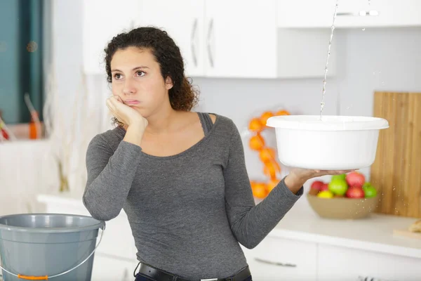 Frau Hält Einen Eimer Während Wassertropfen Von Der Decke Tropfen — Stockfoto