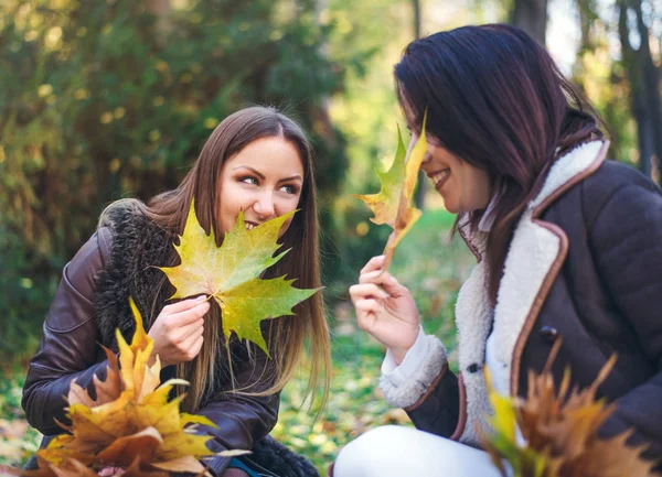 Dos mujeres jóvenes lindas chismorreando al aire libre — Foto de Stock