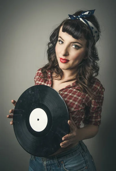 Cute retro pin up girl holding a vinyl record — Stock Photo, Image