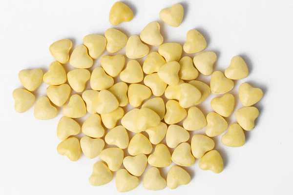 Yellow heart shaped pills - studio shoot — Stock Photo, Image