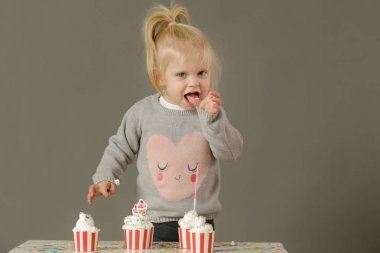  Krem şantili kek yiyen bir çocuğun stüdyo fotoğrafı.