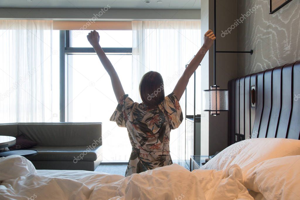 Upper body mobility, Beautiful young woman stretching on bed after waking up