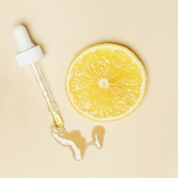 Lemon essential oil, Eye dropper pipette and lemon slices