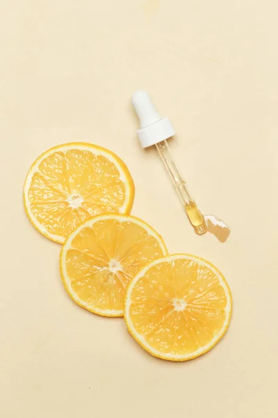 Lemon essential oil, Eye dropper pipette and lemon slices