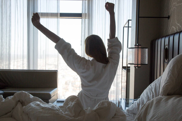 Upper body mobility, Beautiful young woman stretching on bed after waking up