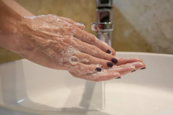 Hygiene. Cleaning hands with soap and water. Washing hands on sink. Preventing diseases by washing your hands.