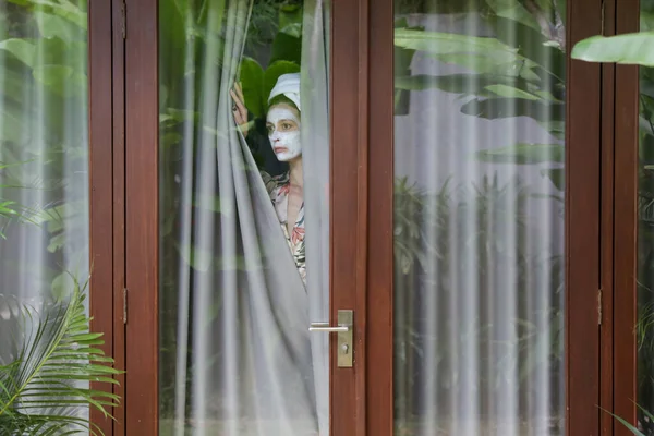 Junge Frau Mit Handtuch Gehüllten Haaren Und Schönheitsmaske Gesicht Die — Stockfoto