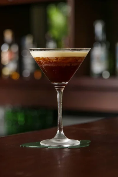 A glass of classic espresso martini on the bar counter