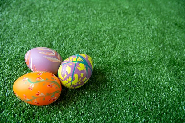 Easter background with Easter eggs. Easter eggs on grass background.  Top view with copy space