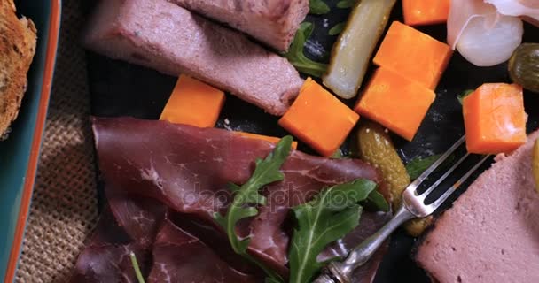 Um prato de carne curada (charcutaria), presunto, salame, patê e queijo — Vídeo de Stock