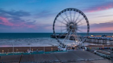 The Victorian Brighton Pier and the Brighton wheel at sunset clipart