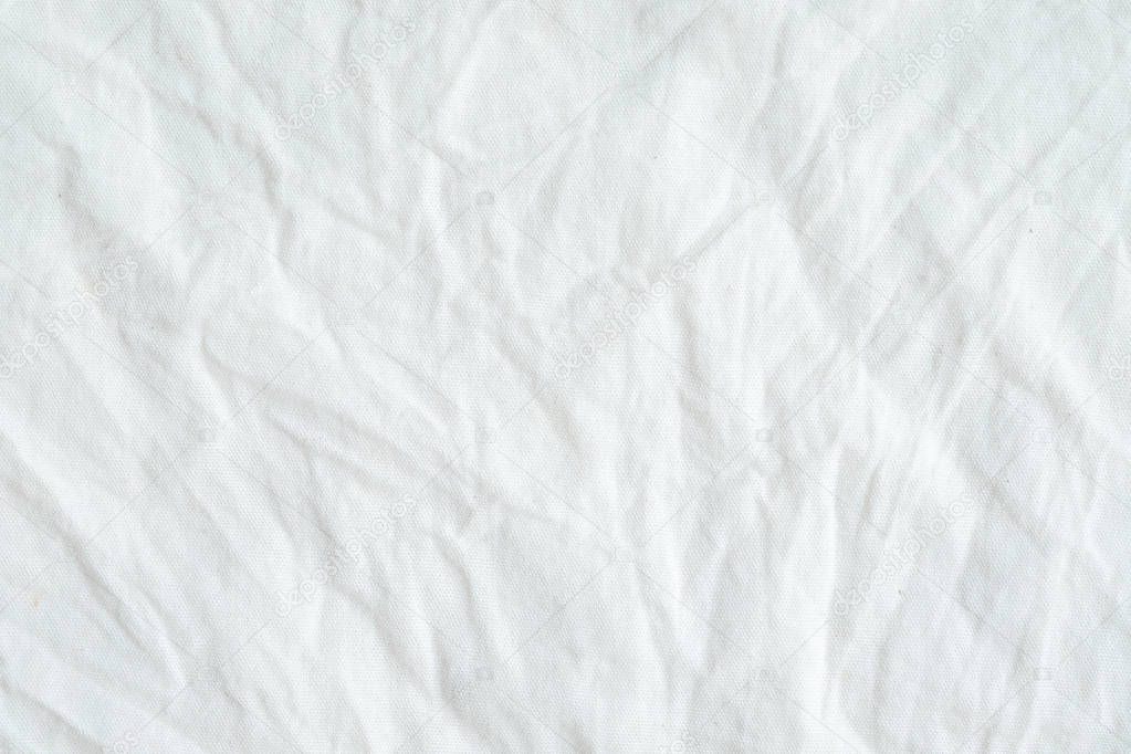 Wrinkled white cotton fabric texture background, wallpaper