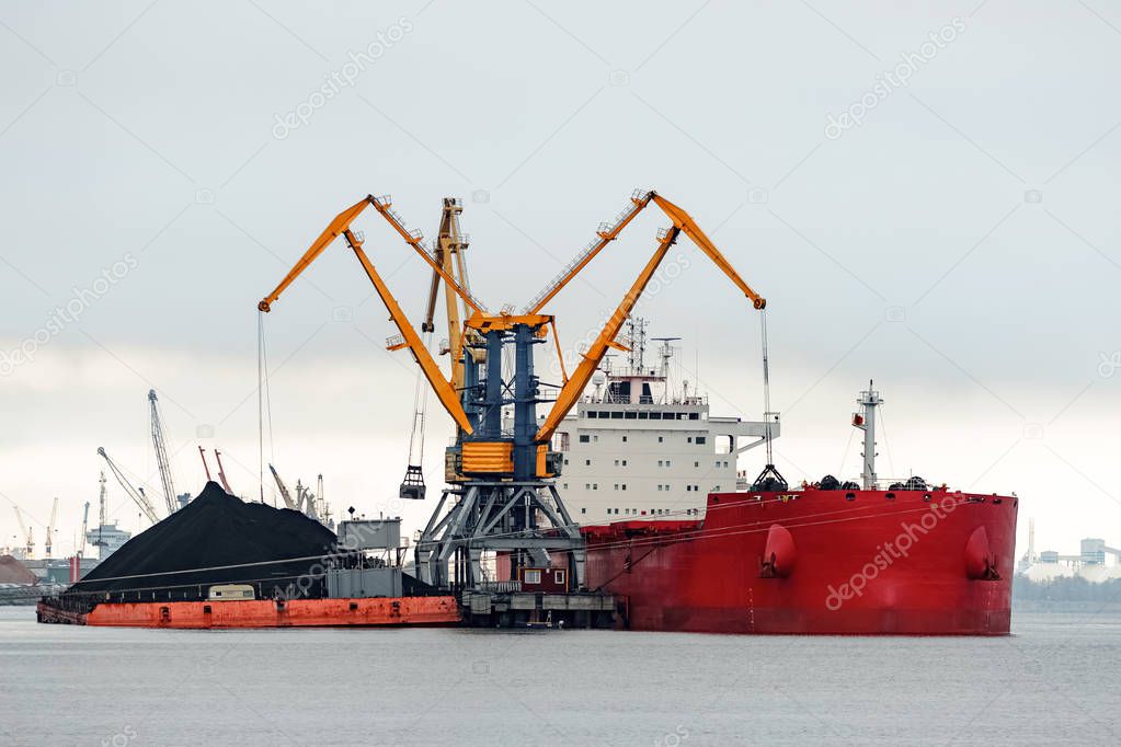 Large red cargo ship loading