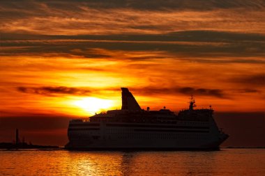 White cruise liner at sunset