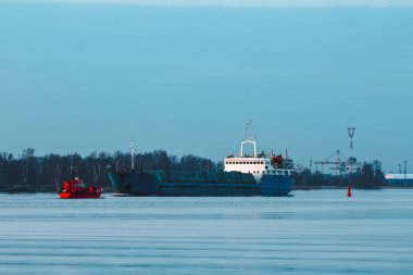 Akşamları yelken mavi kargo gemisi ve kırmızı pilot tekne