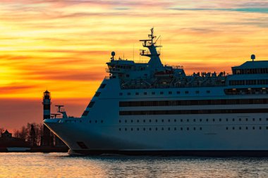 White cruise liner at sunset