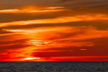 Baltık Denizi üzerinde sıcak ve romantik günbatımı. Sakin manzara