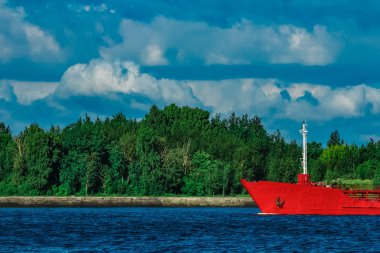 Nehir kenarında hareketli kırmızı kargo tanker gemisi