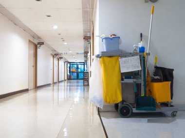 Cleaning tools cart wait for maid or cleaner in the hospital. Bucket and set of cleaning equipment in the hospital. Concept of service, worker and equipment for cleaner and health clipart