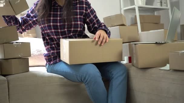 Happy woman Asian young entrepreneur, Checking order in laptop from online shopping store for delivery package to customer from home office, Concept of merchant  business online and eCommerce — Stock Video