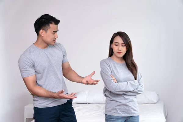 Unhappy Asian Couples standing beside each other and women avoid talking or quarrel, Cause of angry, quarrel, relationship problems and having misunderstanding or disagreement. Family problems concept